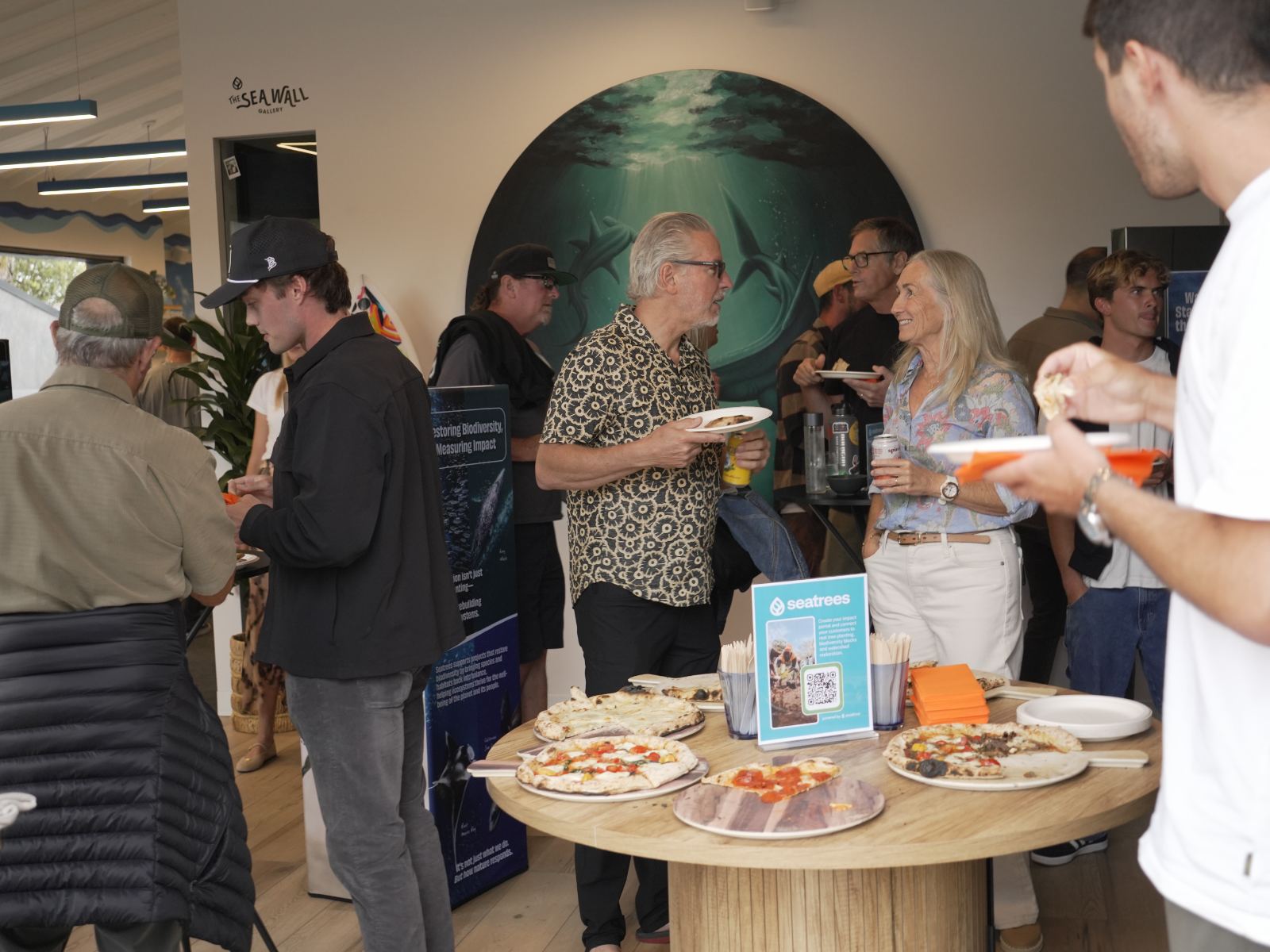 Guests networking over pizza and drinks before the roundtable